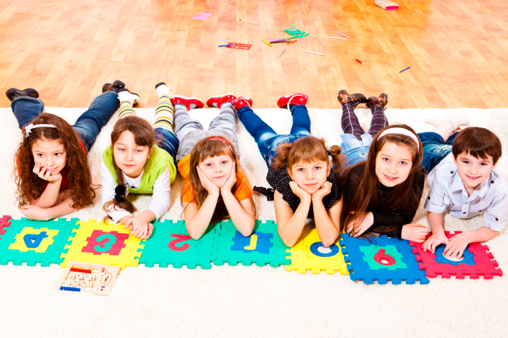 kids-at-school-laying-on-floor-mat